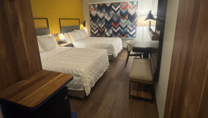 Tru by Hilton guest room with two beds and a work area